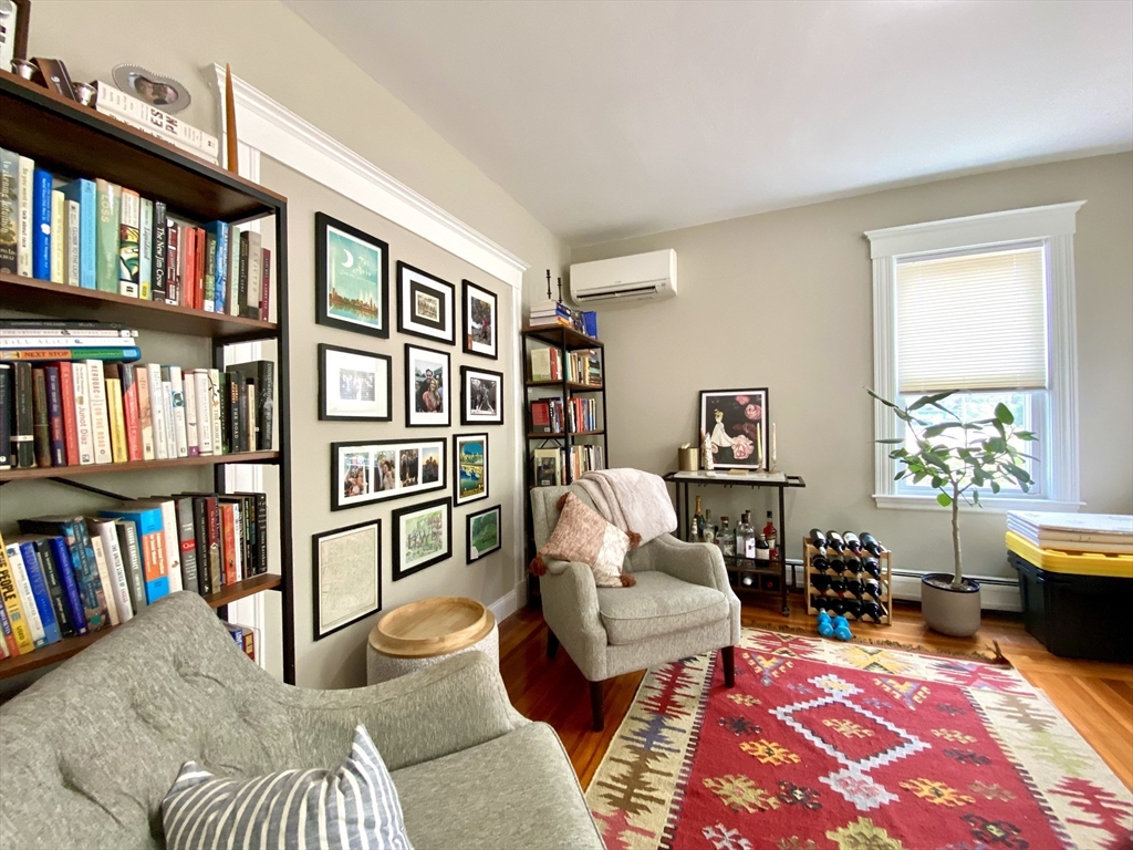 1011 Washington Street, Unit 1 Newton, MA 02460 - Photo 7 of 17 a living room with furniture and a book shelf