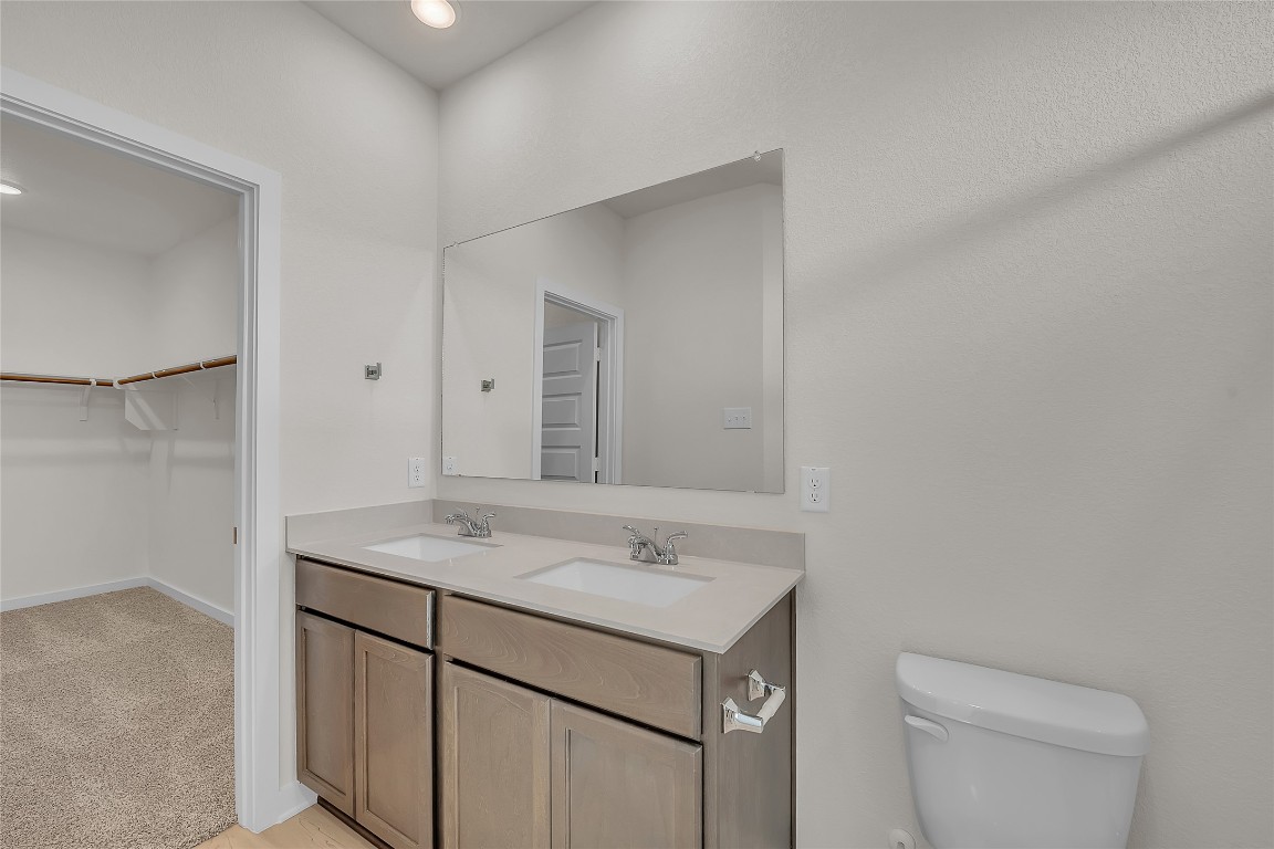 308 Boatright Boulevard Jarrell, TX 76537 - Photo 13 of 31 a bathroom with a granite countertop sink and a toilet