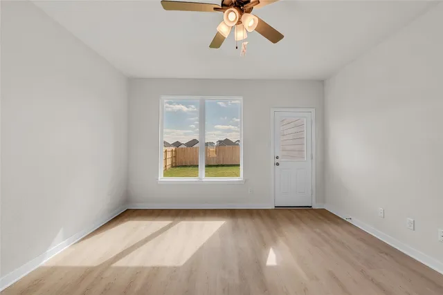 wooden floor in an empty room with a window