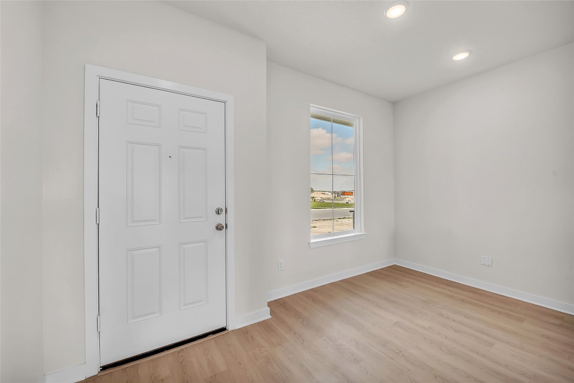 308 Boatright Boulevard Jarrell, TX 76537 - Photo 27 of 31 an empty room with wooden floor and windows