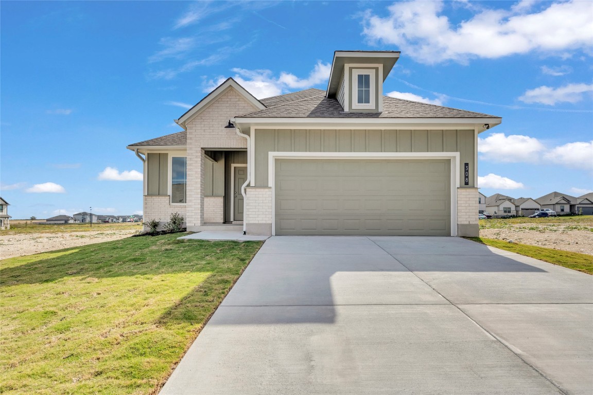 308 Boatright Boulevard Jarrell, TX 76537 - Photo 3 of 31 a front view of a house with garden