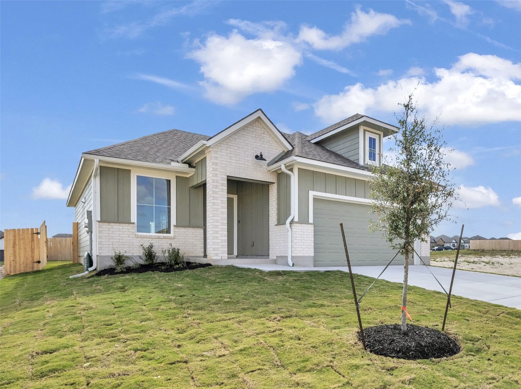 308 Boatright Boulevard Jarrell, TX 76537 - Photo 4 of 31 a front view of a house with a garden