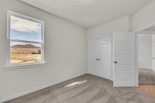 a view of a small space with wooden floor and a window
