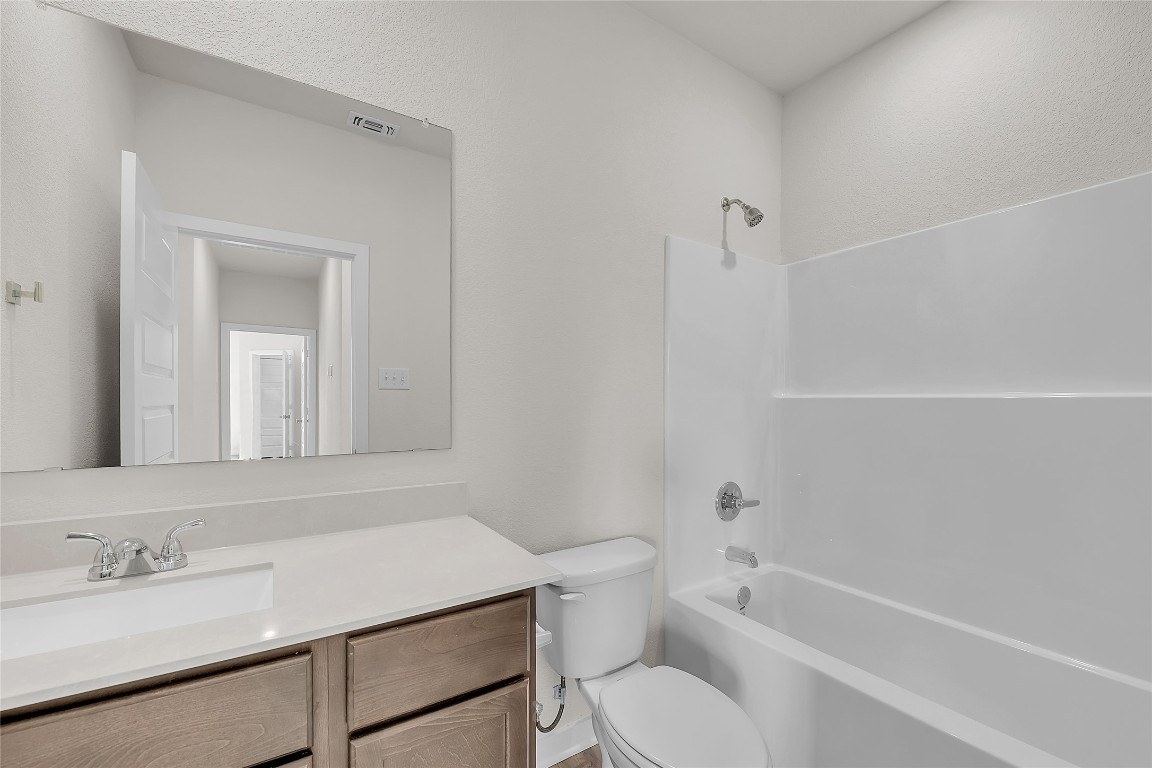 308 Boatright Boulevard Jarrell, TX 76537 - Photo 10 of 31 a bathroom with a sink a toilet and shower