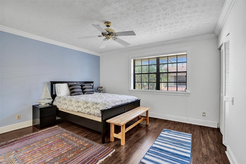 1415 Miami Road, Unit B Fort Lauderdale, FL 33316 - Photo 23 of 59 a bedroom with a bed and wooden floor