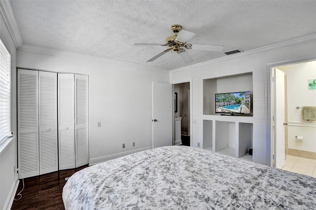 1415 Miami Road, Unit B Fort Lauderdale, FL 33316 - Photo 26 of 59 a bedroom with a bed and a chandelier