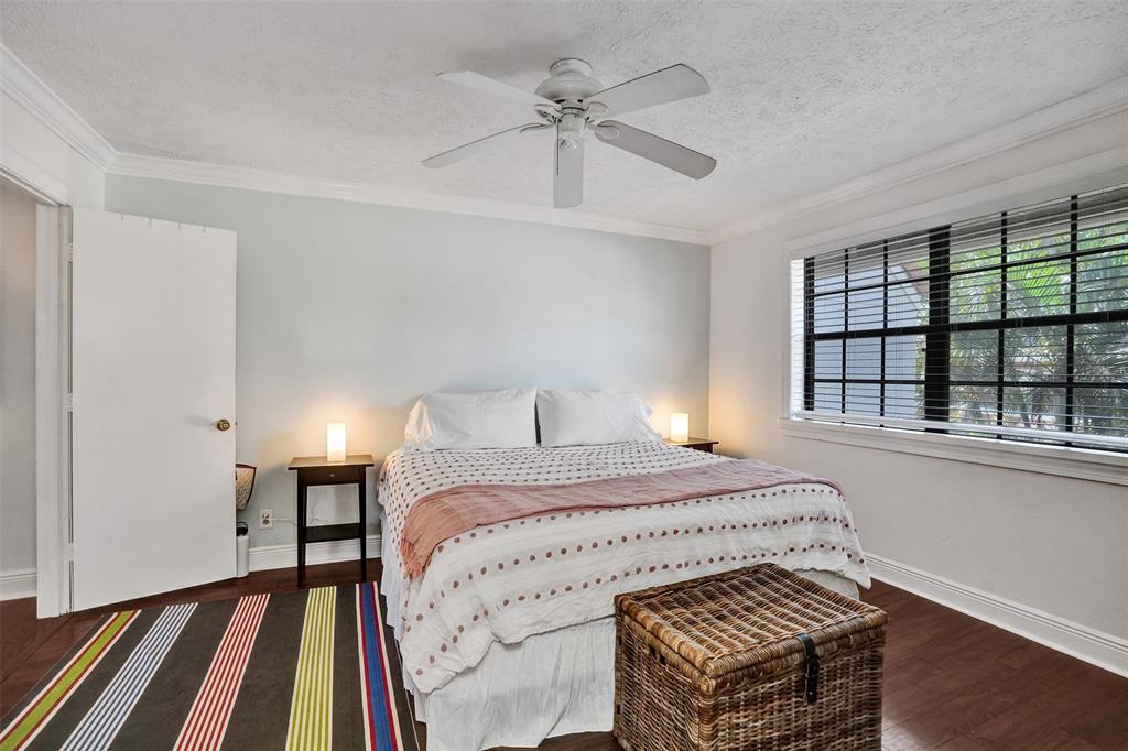 1415 Miami Road, Unit B Fort Lauderdale, FL 33316 - Photo 38 of 59 a bedroom with a bed and a large window with wooden floor