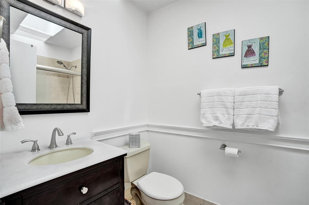 1415 Miami Road, Unit B Fort Lauderdale, FL 33316 - Photo 39 of 59 a bathroom with a granite countertop toilet sink and mirror