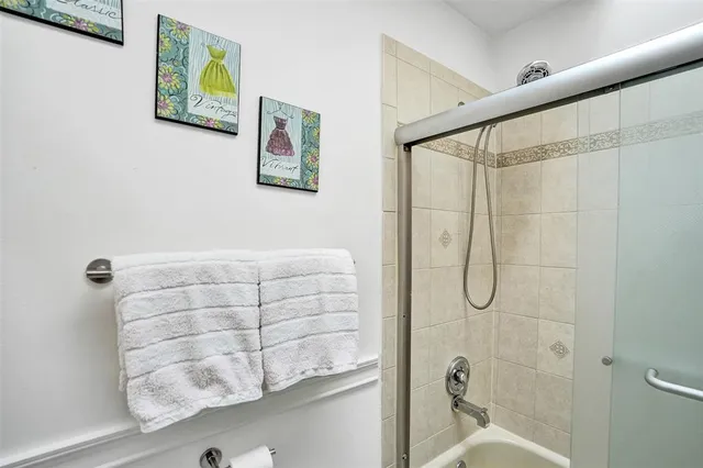 a view of a backyard with potted plants and wooden fence