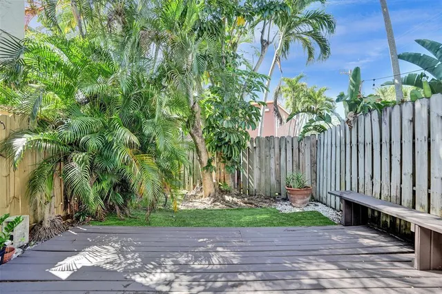 a view of backyard with swimming pool and outdoor seating