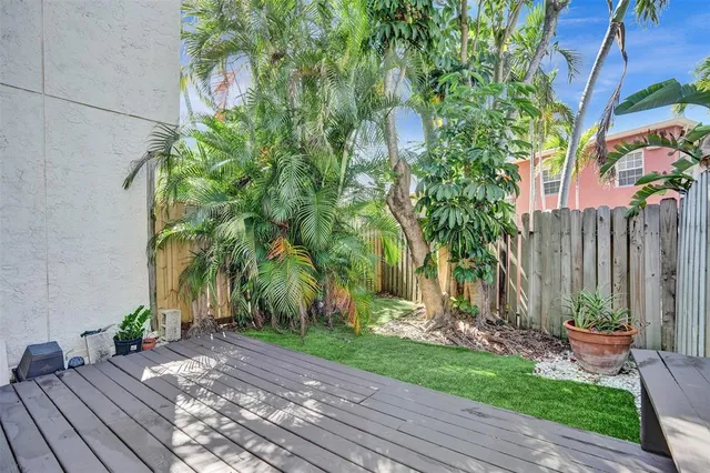 a view of a backyard with wooden fence