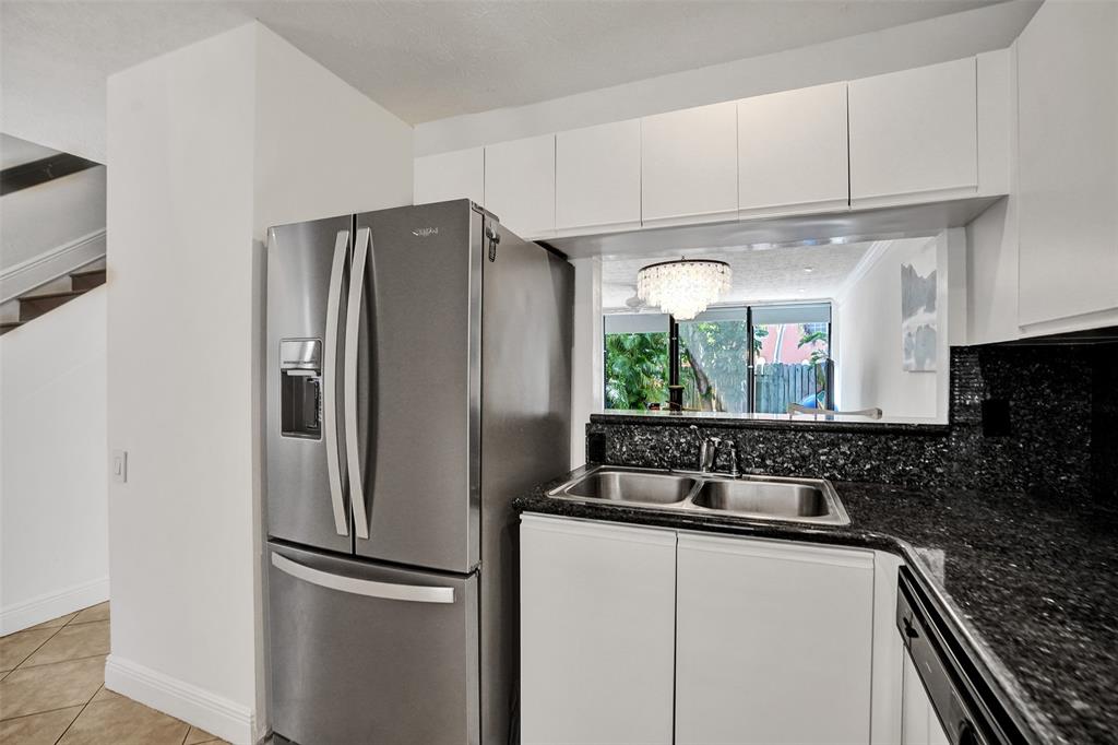 1415 Miami Road, Unit B Fort Lauderdale, FL 33316 - Photo 8 of 59 a kitchen with stainless steel appliances granite countertop a refrigerator and a sink