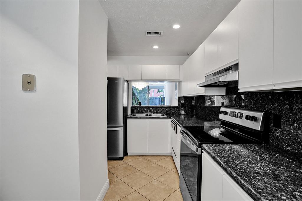 1415 Miami Road, Unit B Fort Lauderdale, FL 33316 - Photo 9 of 59 a kitchen with stainless steel appliances granite countertop a stove a refrigerator and a sink
