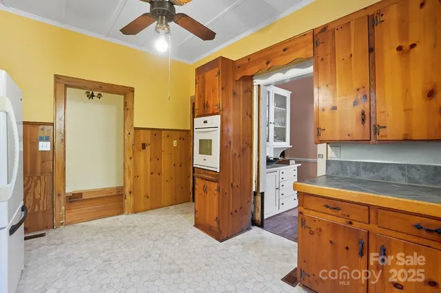 a kitchen with a refrigerator and cabinets