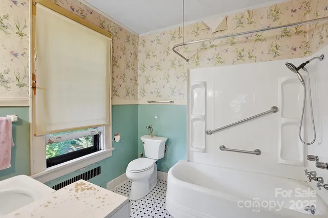a bathroom with a toilet sink and shower