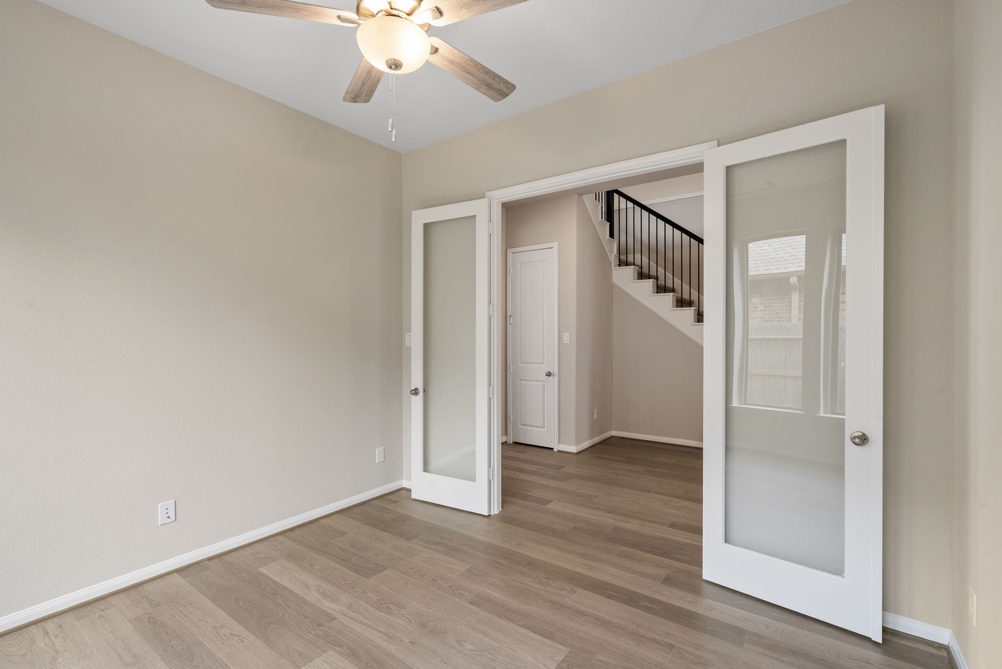 18807 Lima Orange Trail Manvel, TX 77578 - Photo 12 of 32 an empty room with wooden floor and ceiling fan