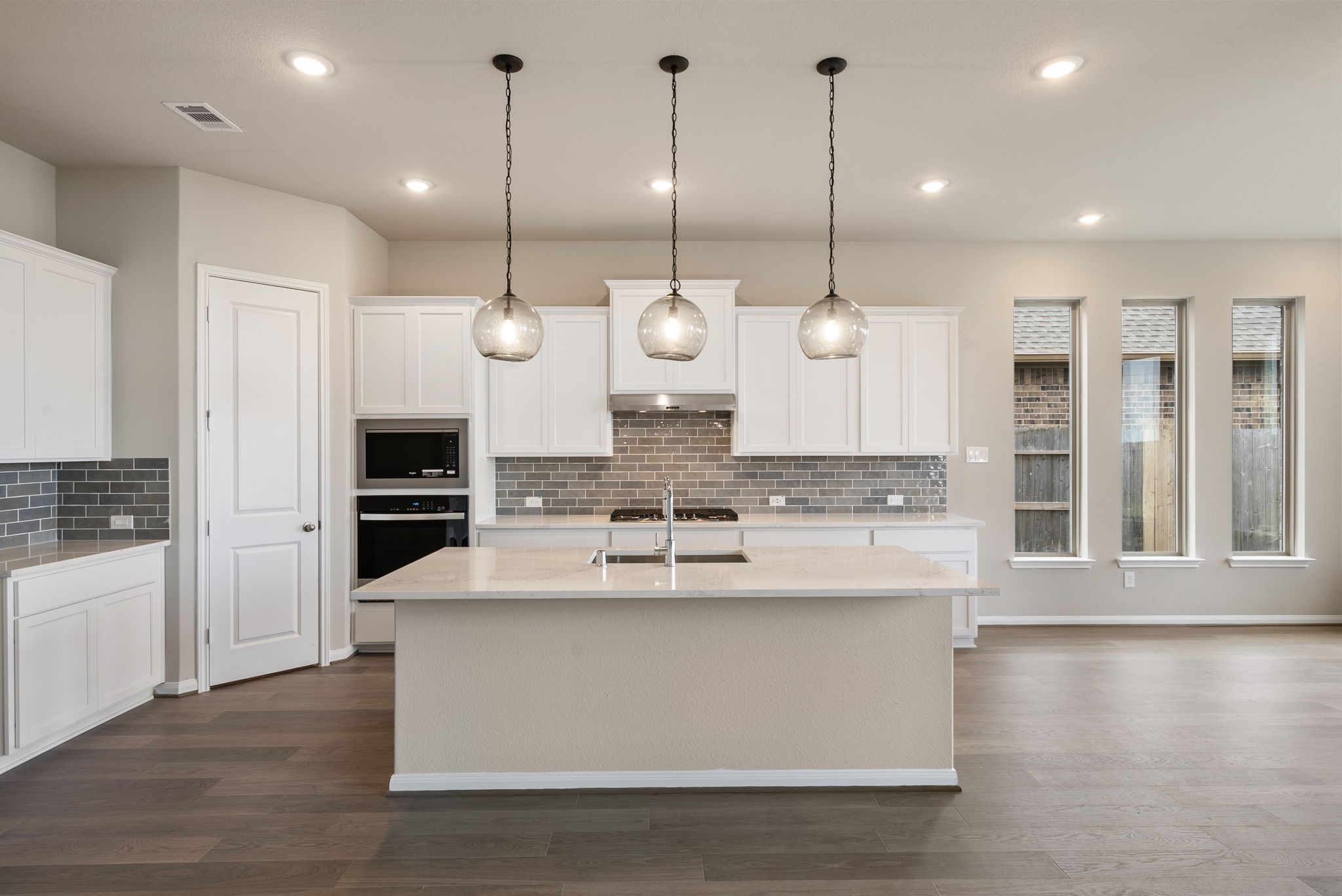18807 Lima Orange Trail Manvel, TX 77578 - Photo 3 of 32 a large kitchen with kitchen island a large island in the center