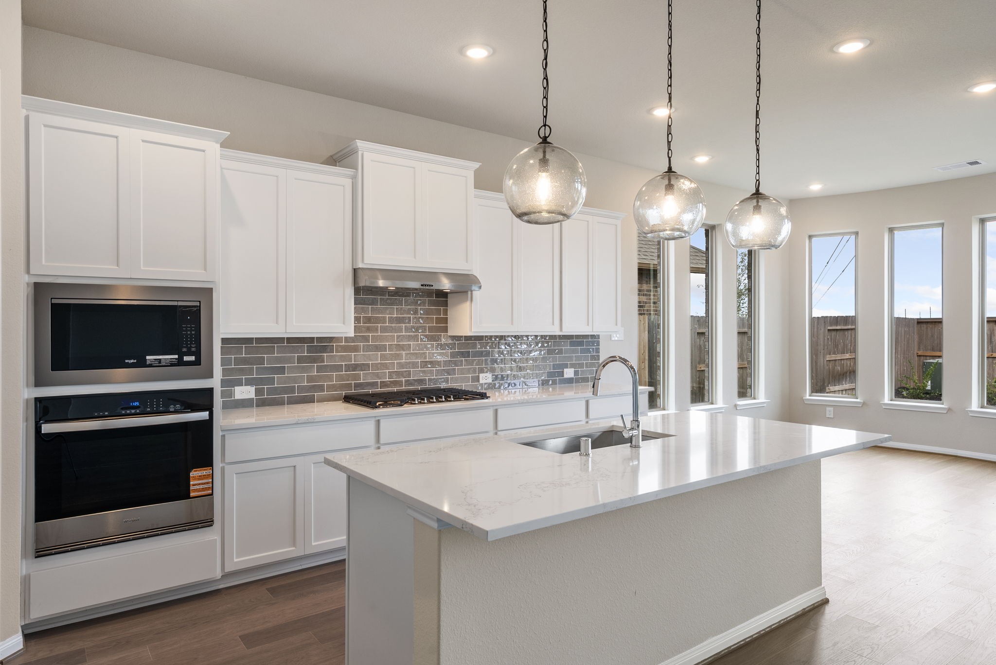18807 Lima Orange Trail Manvel, TX 77578 - Photo 4 of 32 a kitchen with stainless steel appliances granite countertop a sink a stove and a wooden floors