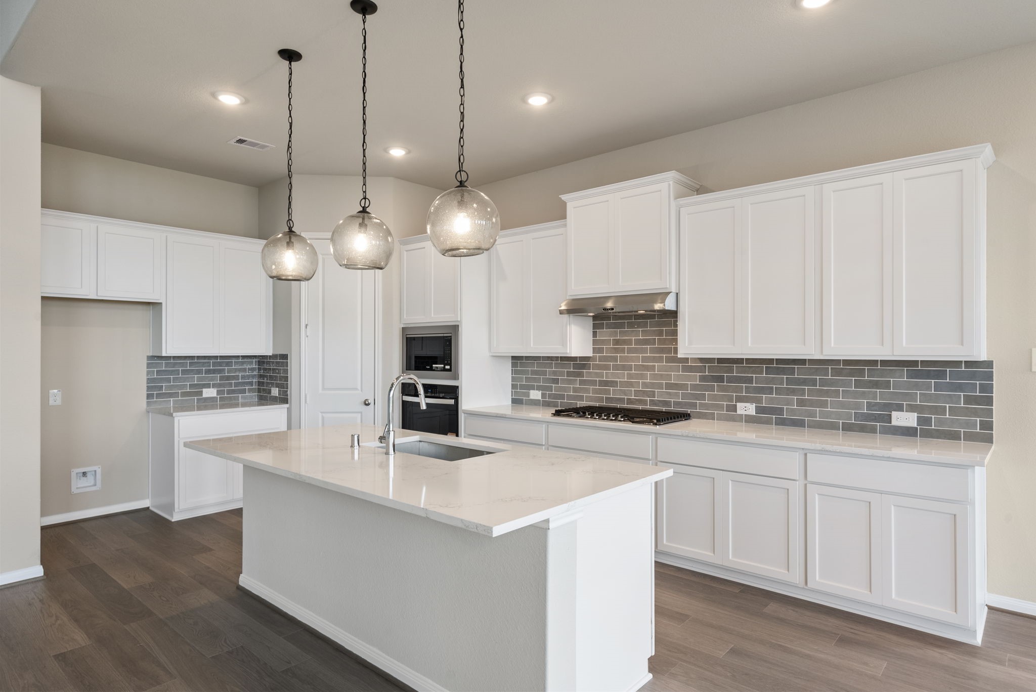 18807 Lima Orange Trail Manvel, TX 77578 - Photo 5 of 32 a large kitchen with kitchen island a sink a center island a stove and a center island