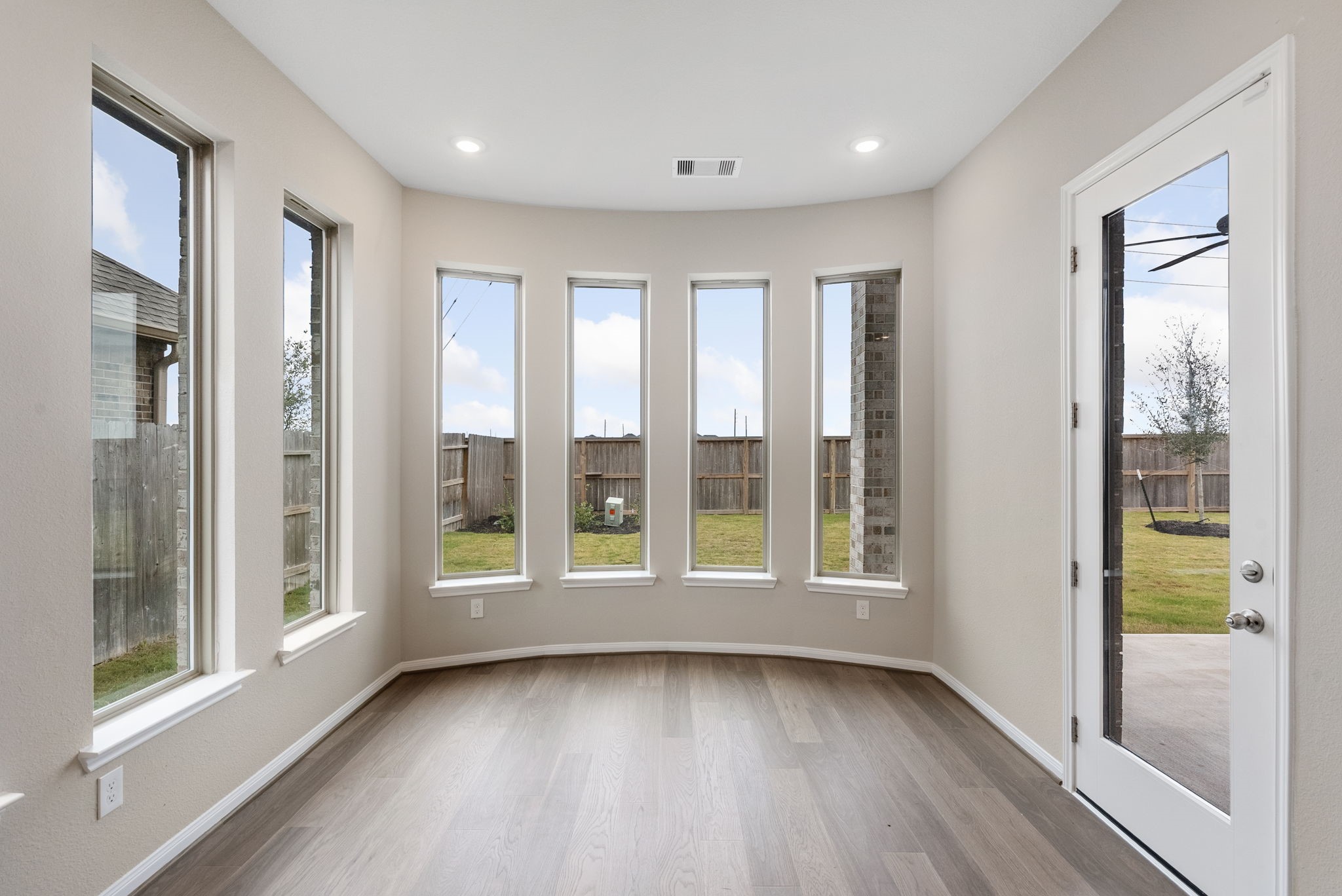 18807 Lima Orange Trail Manvel, TX 77578 - Photo 7 of 32 a view of an empty room with a window and wooden floor