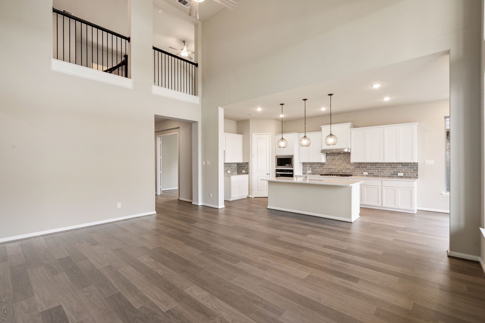 18807 Lima Orange Trail Manvel, TX 77578 - Photo 10 of 32 a open kitchen with white cabinets and stainless steel appliances