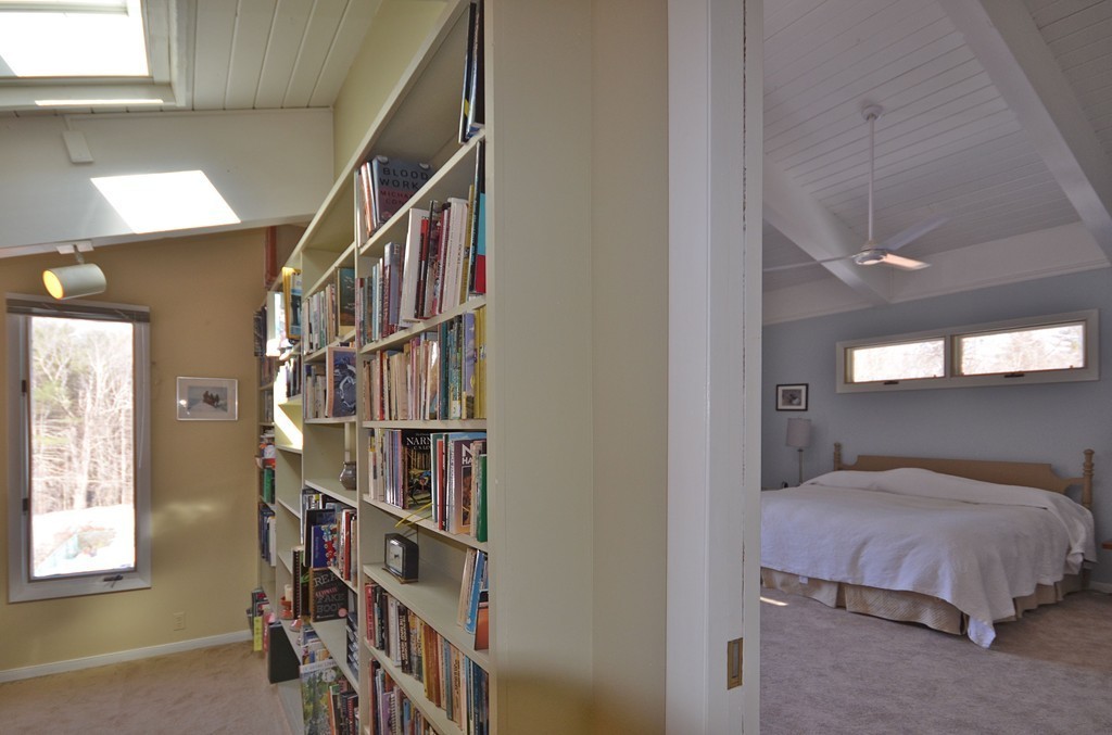 48 Meetinghouse Road Pelham, MA 01002 - Photo 21 of 30 a bedroom with a bed and a book shelf