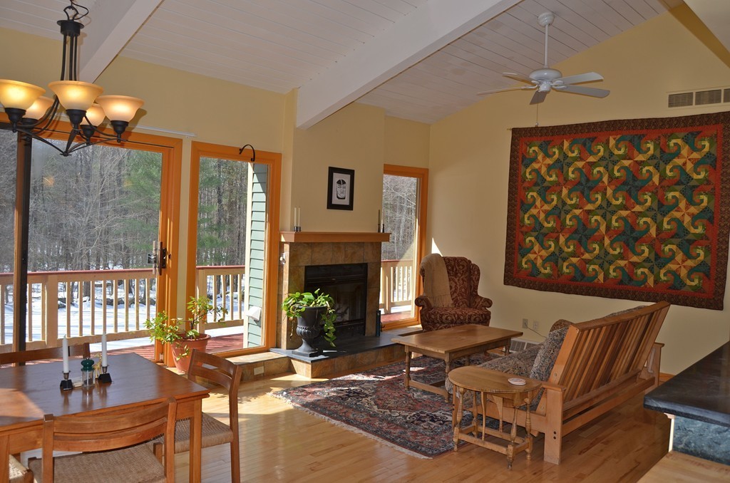 48 Meetinghouse Road Pelham, MA 01002 - Photo 6 of 30 a living room with furniture a fireplace and a chandelier
