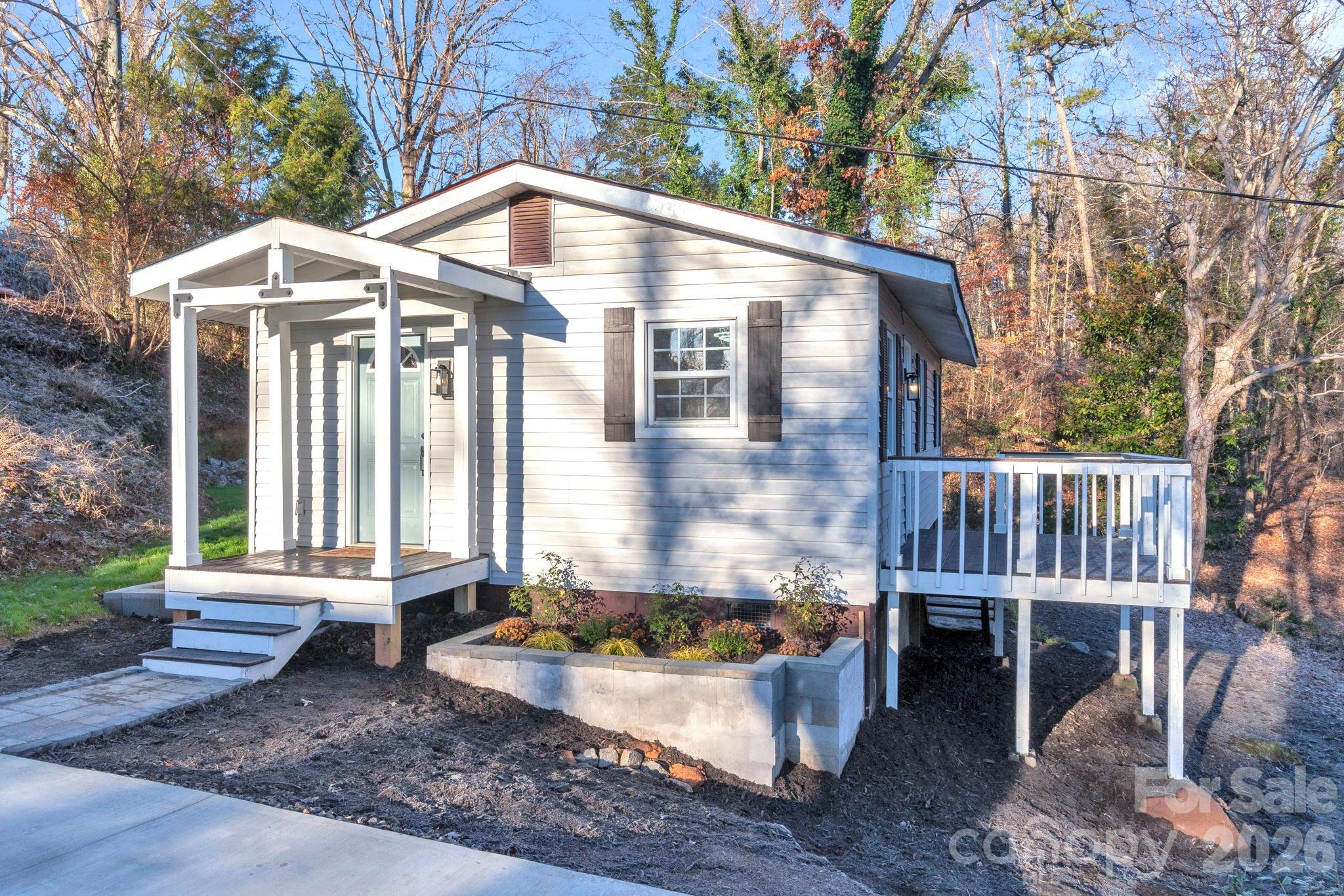 49 East Livingston Street Tryon, NC 28782 - Photo 2 of 27 a front view of a house with yard and trees