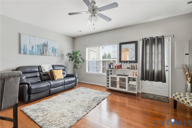 a living room with furniture and wooden floor