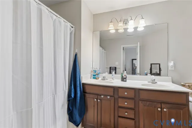 a bathroom with a double vanity sink and a mirror