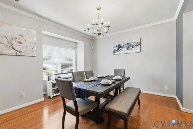 a view of a dining room with furniture and chandelier