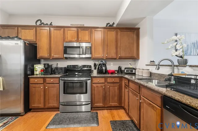 a kitchen with a sink stove and refrigerator