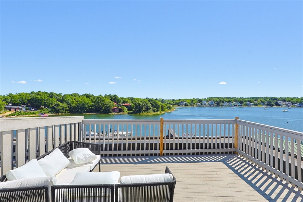45 Main Street, Unit 35 Wareham, MA 02571 - Photo 26 of 34 a view of a balcony with wooden floor and fence