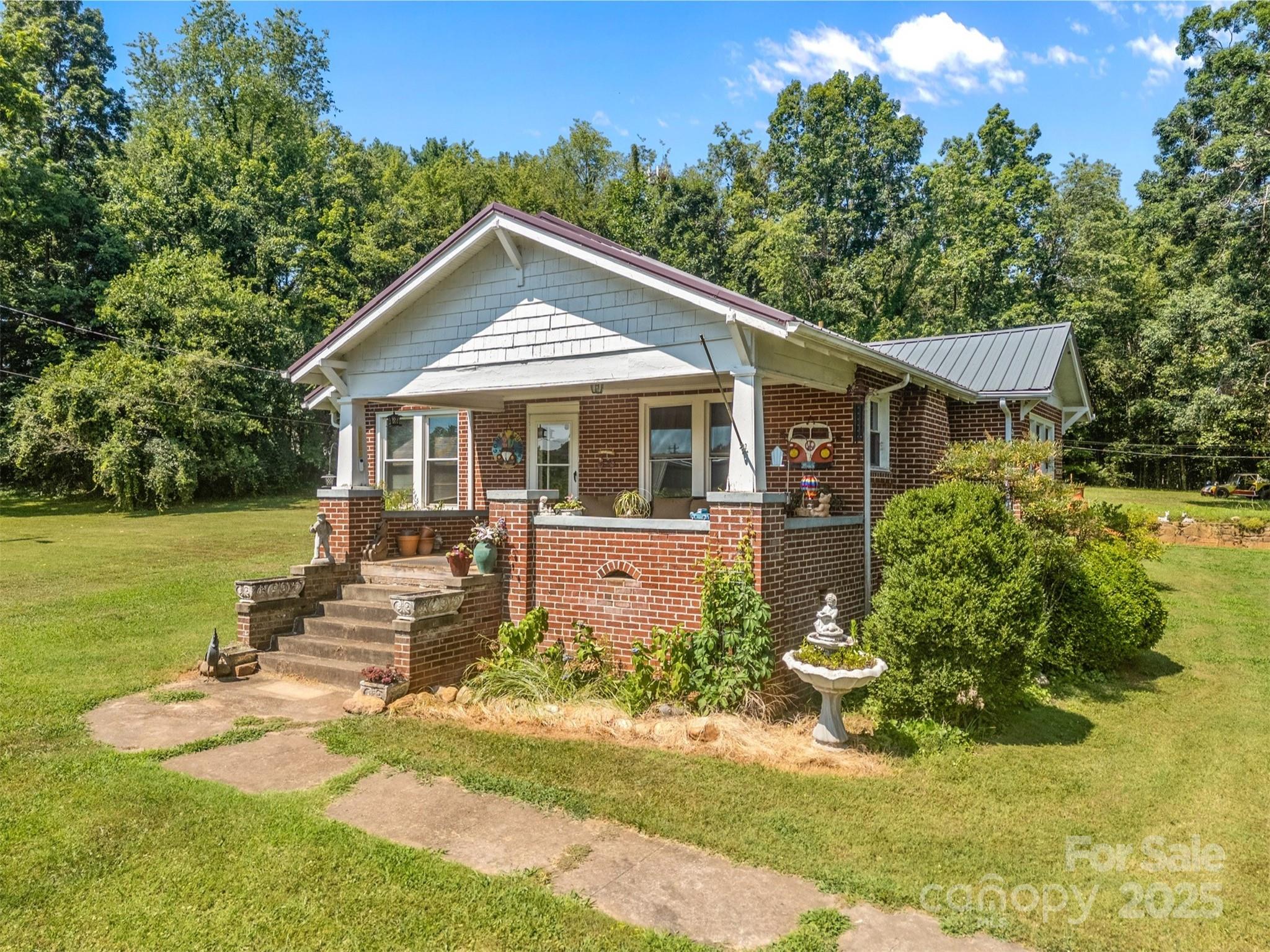 2401 Highway 181 Morganton, NC 28655 - Photo 2 of 17 a front view of a house with a yard table and chairs