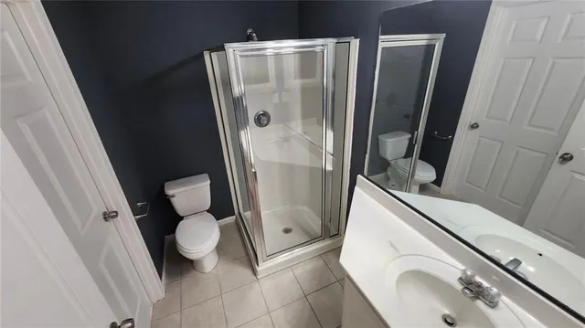 a bathroom with a sink and mirror with toilet