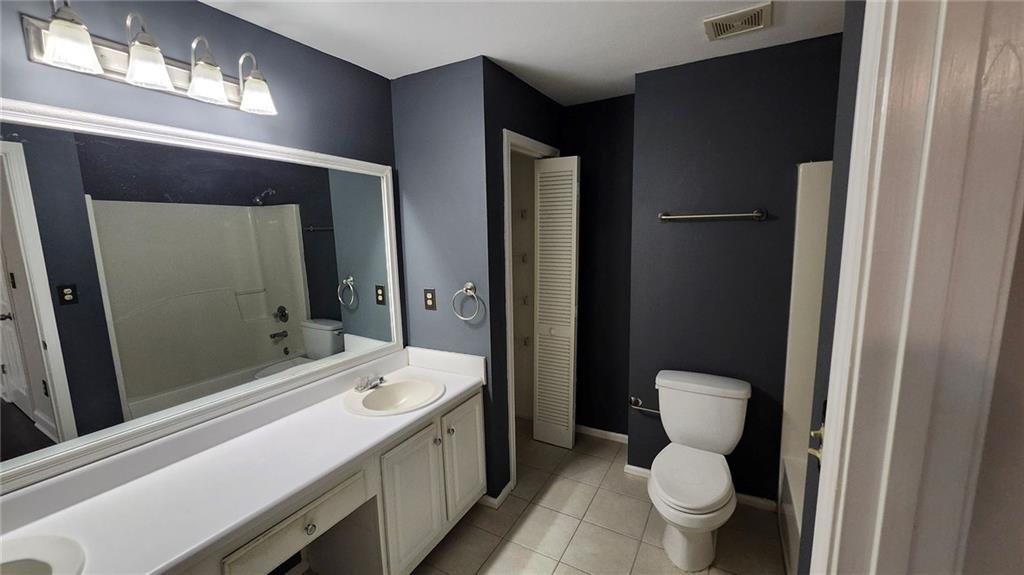 1347 Keys Crossing Drive Northeast Atlanta, GA 30319 - Photo 10 of 12 a bathroom with a sink toilet a shower and a mirror