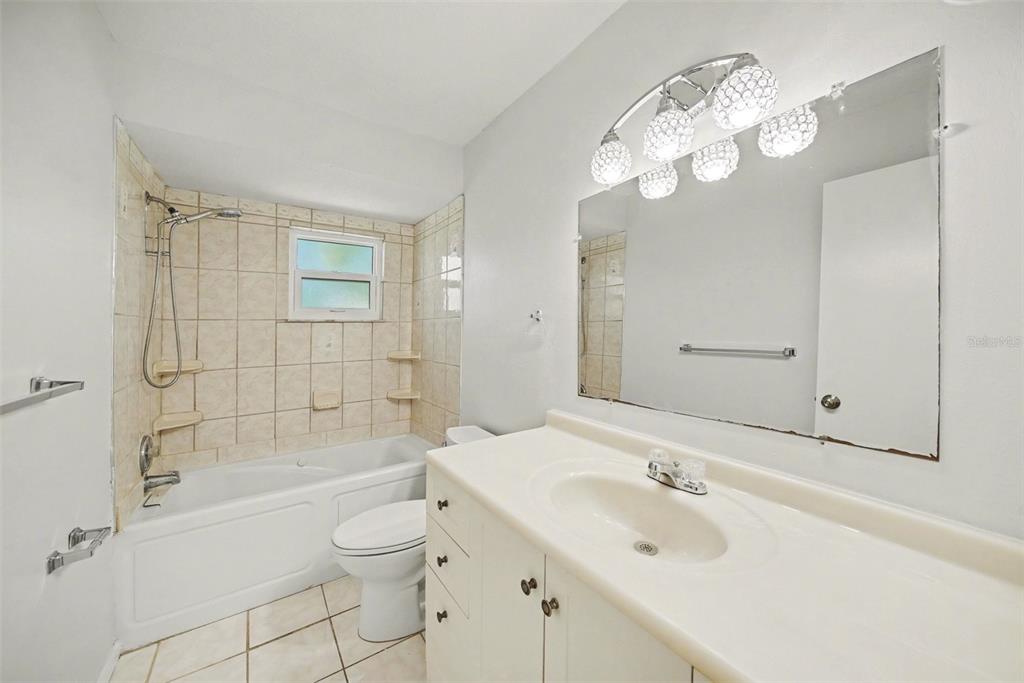 113 Ruskin Avenue Spring Hill, FL 34606 - Photo 21 of 32 a bathroom with a sink a toilet and shower