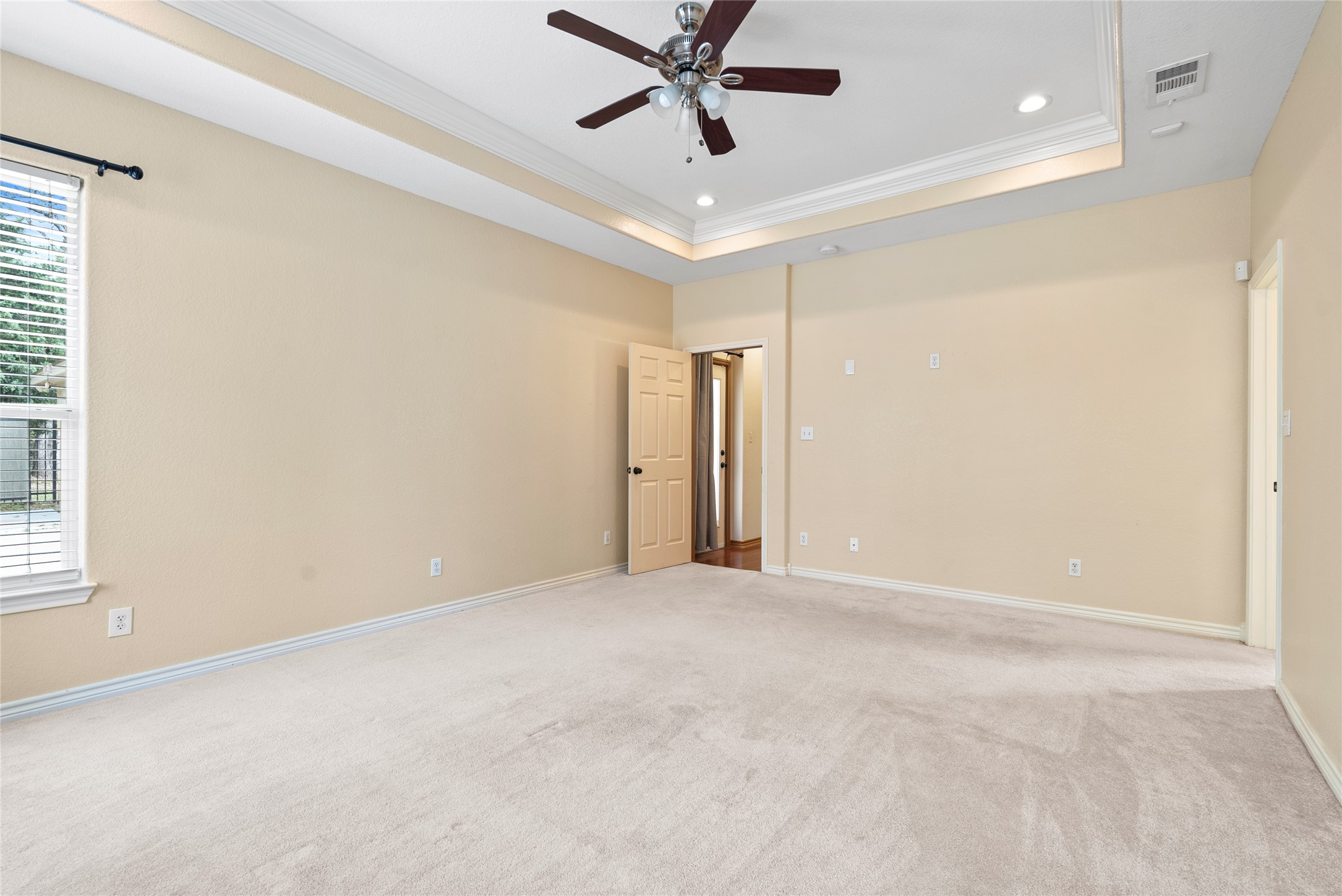 330 Arbors Circle Elgin, TX 78621 - Photo 16 of 37 crown molding, a ceiling fan, light carpet, a raised ceiling,