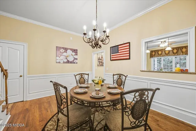 a kitchen with kitchen island a large counter top space a sink stainless steel appliances and cabinets