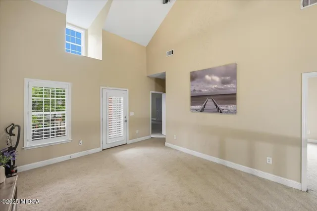 a view of a livingroom with a chandelier fan