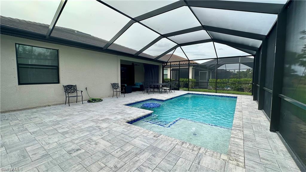 a view of swimming pool with a patio and a yard