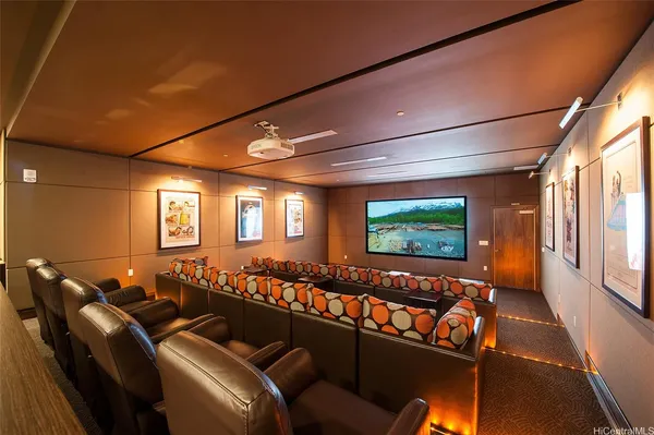 a room with furniture projector and screen