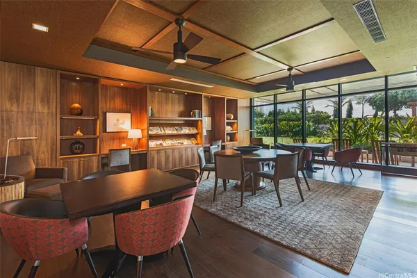 a dining room with furniture a chandelier and wooden floor