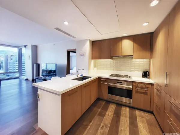 a kitchen with a sink stove and cabinets