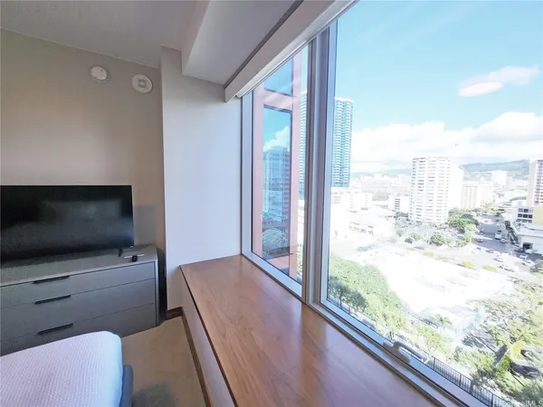 a living room with a large window and a flat screen tv