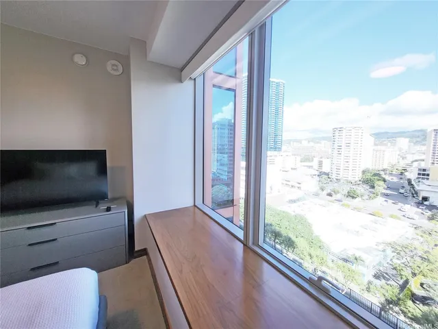 a living room with a large window and a flat screen tv