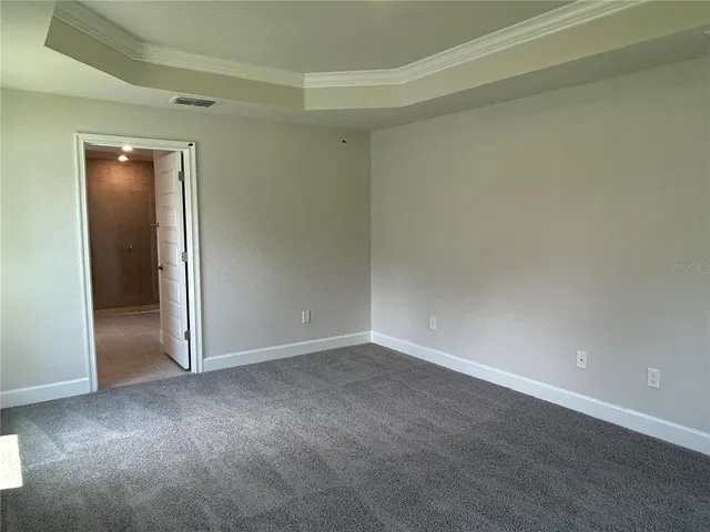 an empty room with closet and mirror