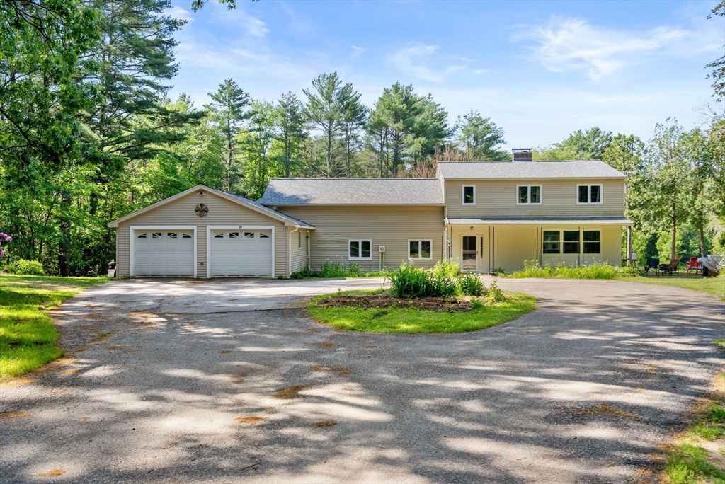 87 R Ruggles Street Gilbertville, MA 01031 - Photo 2 of 39 a front view of a house with a yard and garage