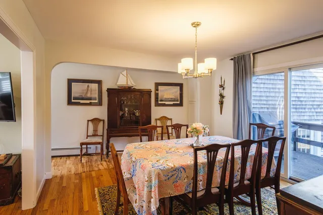 a view of a dining room with furniture and chandelier