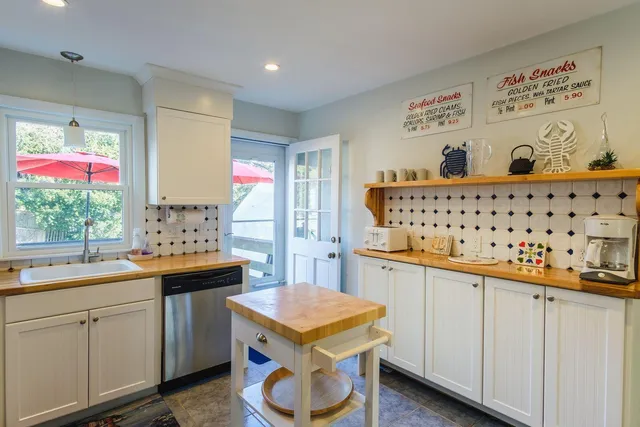 a kitchen with a sink a stove and cabinets